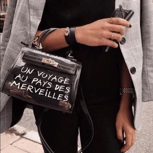 Un Voyage Transparent Handbag